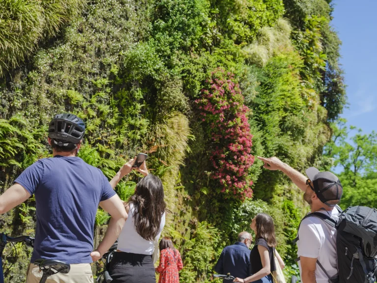 Hidden Madrid bike tour 16 Travelers admire and photograph the vertical garden wall of CaixaForum Madrid, the gateway to the Barrio de las Letras on the Hidden Madrid bike tour route