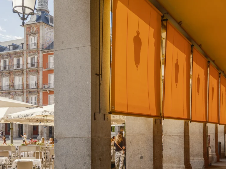 Historic Madrid Walking Tour 17 Yellow market stall blinds along the Plaza Mayor arcades in Madrid, on a Dinamo Historic Madrid Walking Tour