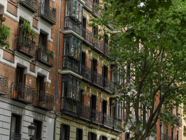 Private Madrid walking tour 3 Brick facades with glassed-in balconies on a quiet street on a private Madrid walking tour