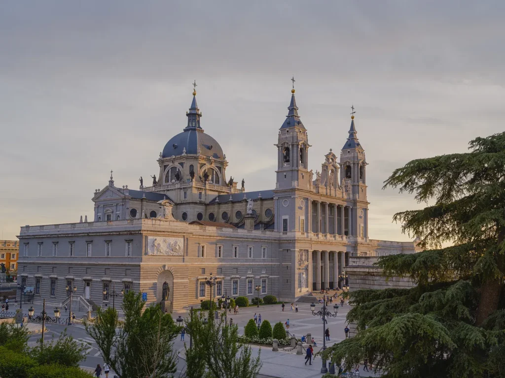 unusual things to do in Madrid 15 The Almudena Cathedral seen from the viewpoint in the golden light, a stop on this cycling tour, Madrid