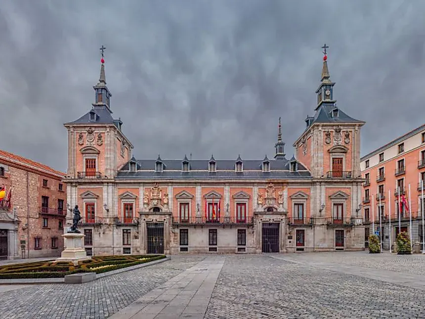 unusual things to do in Madrid 16 The Casa de la Villa on the empty Plaza de la Villa under a stormy sky, one of the best things to do in Madrid away from the crowds